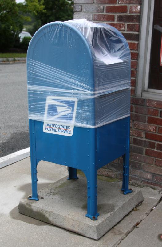Post Office mailboxes were covered in plastic Friday, in preparation for the storm. Signs under the plastic read: "Please deposit your mail at your local Post Office." BY JAIME REBHAN