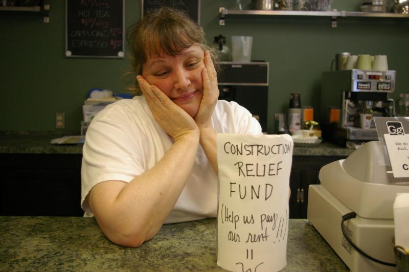 Kristine Hastreiter, owner and chef at Gourmet and Gourmand on Main Street, sits behind her counter and her "construction relief fund" jar filled with loose money from customers attempting to help her with her plight. Hastreiter said that she has already started digging into her personal funds and if things don't improve, she may have to shut down by the beginning of July. BY RISHI SIDHU