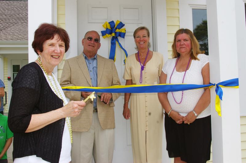 Priscilla Porter, member of the Friends of the Wareham Free Library, gets ready to hand over the ceremonial key at the official Grand Opening of the Spinney Memorial Library on Monday. From left to right, Porter, Selectman Alan Slavin, State Representative Susan Gifford, and Wareham Free Library Director Denise Medeiros. BY RISHI SIDHU