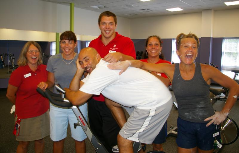 YMCA staff in the new group exercise room. Back row from left to right, Marketing and Development Director Jo-Ann Watson, Executive Director Laura Prisco, Assistant Wellness Director Brent Rusinoski, Assistant Program and Camp Director Donna Maynard, and Aquatics Director Melissa Dyer. Front, Senior Program Director Lu Brito sits on one of the 16 new cycles in the exercise room. BY RISHI SIDHU