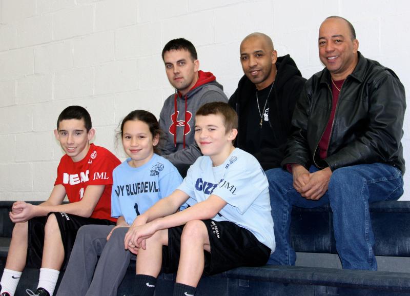 Kenny Fontes, top right, CEO of the JBA basketball league and newly-named director of the Wareham Boys & Girls Club, enjoys a game on Jan. 26. Fontes is seen with JBA President Joel Watters, Senior Executive Officer Gary Tavares, and players Joseph Fiori, Annmarie Perry, and Luke Still. BY JAIME REBHAN