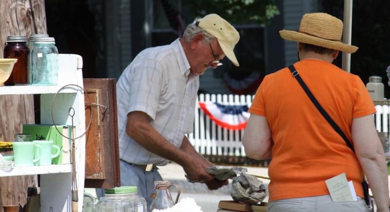 Dave Lamson of Hyannis wraps up an item for a patron at the Wareham Historical Society's annual July 4 Antiques Show on Thursday. BY JAIME REBHAN