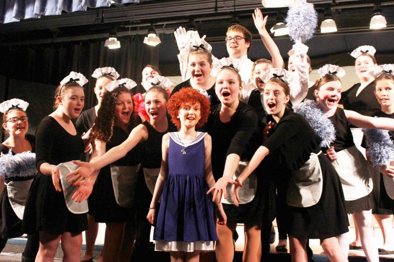 Annie (Abby Wiksten) is welcomed into the home of Oliver Warbucks (played by Matthew Thompson) by the maids and butlers during the song “I Thnk I’m Gonna Like It Here.” BY ZARRIN TASNIM AHMED