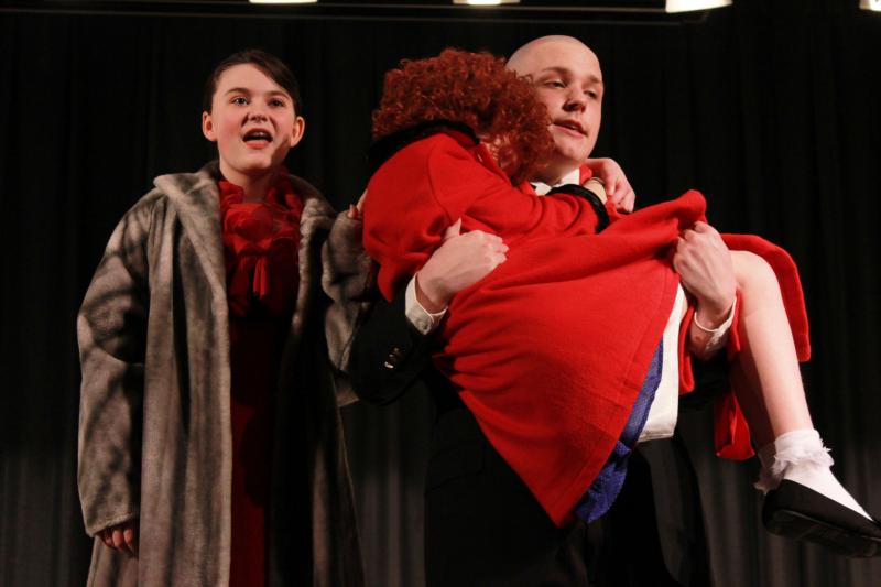 Oliver Warbucks (Matthew Thompson) carries a tired Annie (Abby Wiksten) home after a night out with Grace Farrell (Jenna Maloney). BY ZARRIN TASNIM AHMED