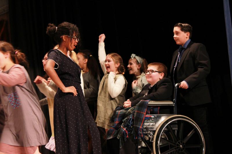 Miss Hannigan (Solana Priestly) is amazed to see President Franklin Roosevelt (Robert Haskell). while orphans rush to their Christmas presents. The president’s aide was played by Glenn Barrows). BY ZARRIN TASNIM AHMED