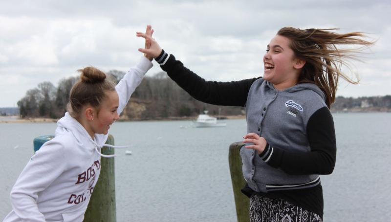 Arielle Troupe (left) and Ava O'Driscoll (right) fulfill scavenger hunt item number six: take a picture of two people giving each other a high five and Wickets Island. BY ZARRIN TASNIM AHMED
