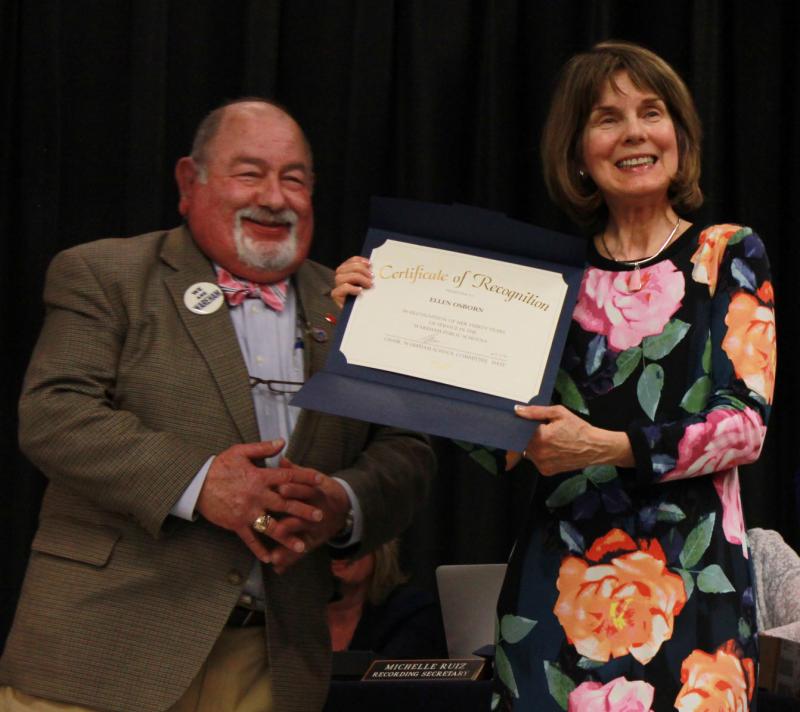 School Committee Chairman Melvin Lazarus (left) presents Ellen Osborne with a Certificate of Recognition for 30 years of service as an art educator. At John W. Decas Elementary School, she is also considered an interior decorator. BY ZARRIN TASNIM AHMED