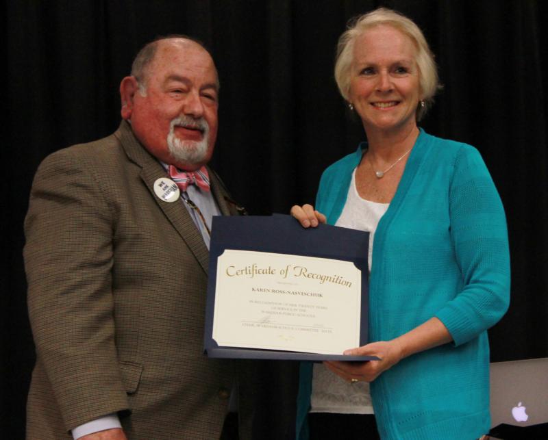 Karen Ross-Nasveschuk (right) is recognized for her 20 years of service to the school system as a secretary for Minot Forest Elementary School by Melvin Lazarus, chair of the School Committee (left). BY ZARRIN TASNIM AHMED