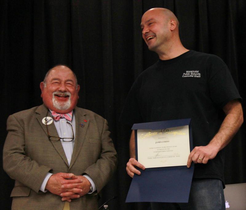James Couto (right) has served as a custodian at the Wareham Middle School for 20 years. He was recognized for his service by School Committee Chair Melvin Lazarus (left), the School Committee, and members of the community on Wednesday night. Principal Dan Minkle described Couto as "always having a sense of humor." BY ZARRIN TASNIM AHMED