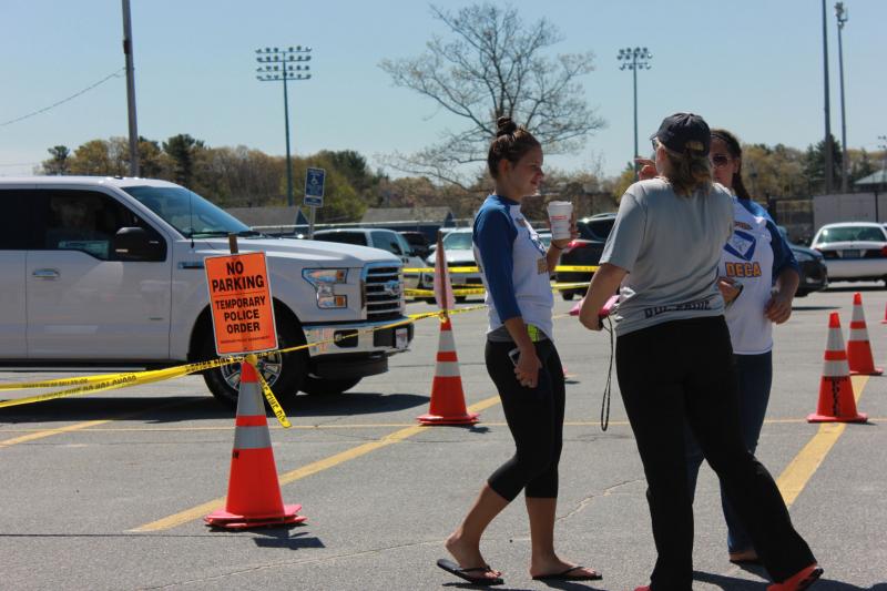 DECA students wait while the Ford F-150 takes off with a participant test driving the vehicle during Ford's Drive4UrSchool, a fundraising program that raises up to $6,000. BY ZARRIN TASNIM AHMED