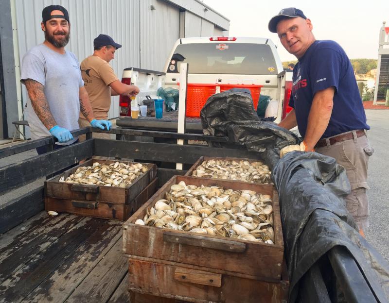 Bill Atwood and Gordon Foot prepare to transfer the clams from the Wareham Community Associates bake to serving tables, where volunteers doled out all the fixings to attendees. BY JAIME REBHAN