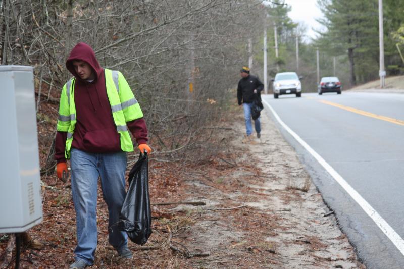 Wareham Key Club member Josh Gallagher walks along Minot Avenue with Col. Lt. Matthew Stanton, the club's advisor, following behind. BY MATTHEW BERNAT