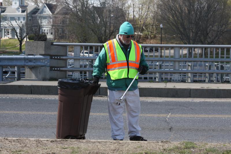 Selectman Alan Slavin, a founding member of Don't Trash Wareham, cleans up near the Narrows on Sunday. BY MATTHEW BERNAT