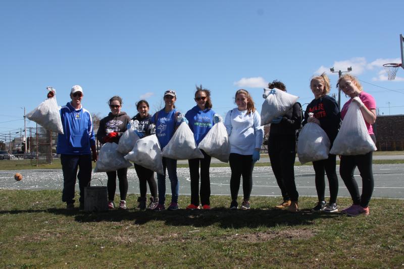 Members of the girls tennis team with trash they picked up at Lopes Playground in Onset on Sunday. BY MATTHEW BERNAT