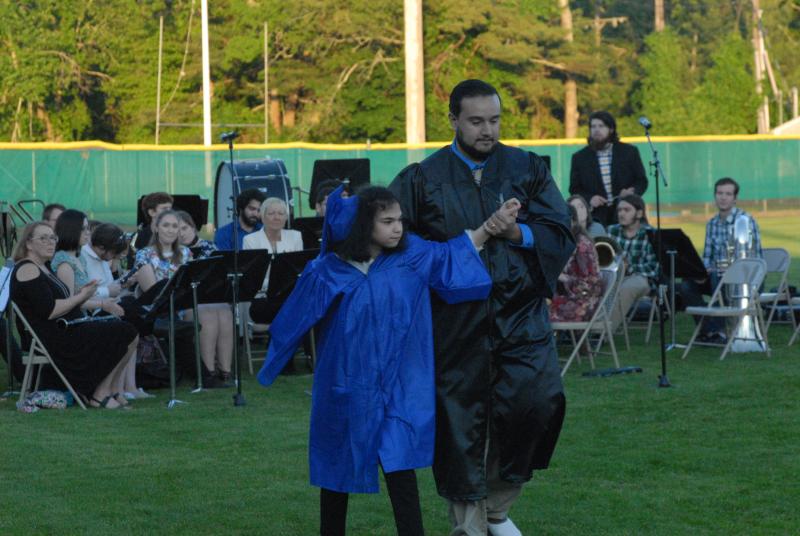 Abigail Pagan-Buil walks to receive her diploma to a standing ovation from her fellow graduates. BY LYDIA GOERNER