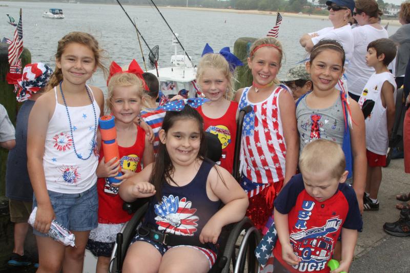 Members of the Junior Color Guard cheered on each boat, spraying them with water guns and picking out their favorites. BY LYDIA GOERNER