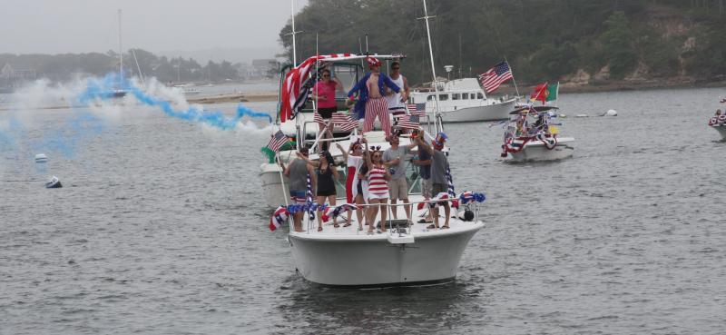 "Valhalla" wows the crowd with red, white and blue smoke during the boat parade. BY EVAN DEBEVEC-MCKENNEY
