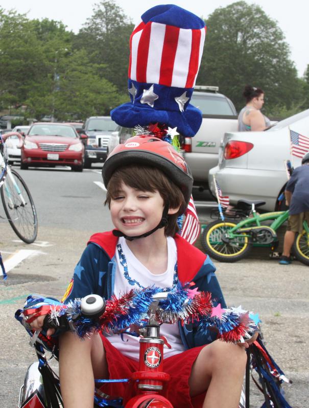 Will Regan, age 5, decorated his bike as an "Americanasaurous" for the children's bike parade, held immediately after the Blessing of the Fleet. BY LYDIA GOERNER