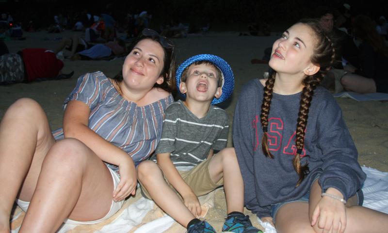 (From left) Natalya Rivera, Desmond Murphy and Lucy Murphy enjoy the fireworks display. BY LYDIA GOERNER