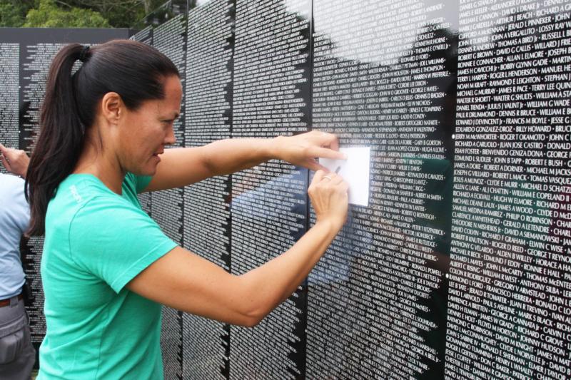 Jill Robertson makes a rubbing of her grandfather's name. Leo Horan was killed in action in the Vietnam War at age 32. BY LYDIA GOERNER