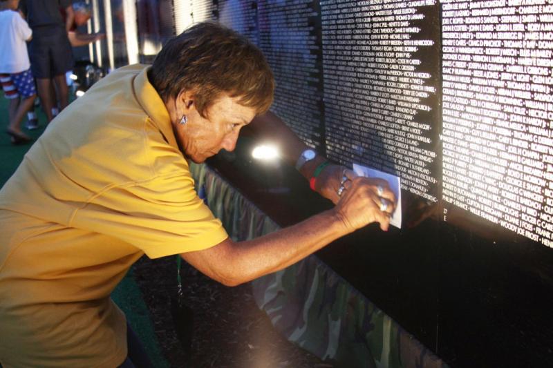 Jo-Ann Morgan makes a rubbing of her high school classmate's name. Eugene Cormier, who graduated with Morgan, was killed in action at age 22. BY LYDIA GOERNER