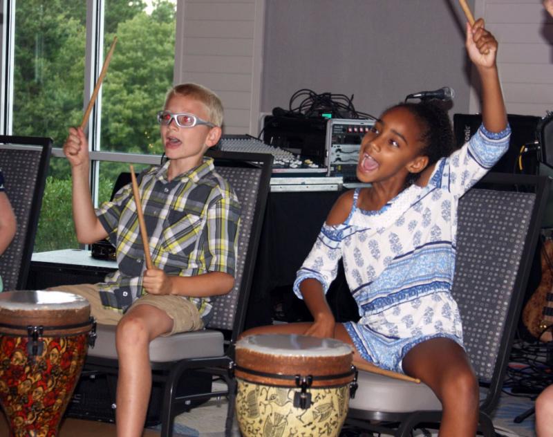 Boys & Girls Club members demonstrate their drumming skills after Jo Sallins' summer workshops. BY LYDIA GOERNER