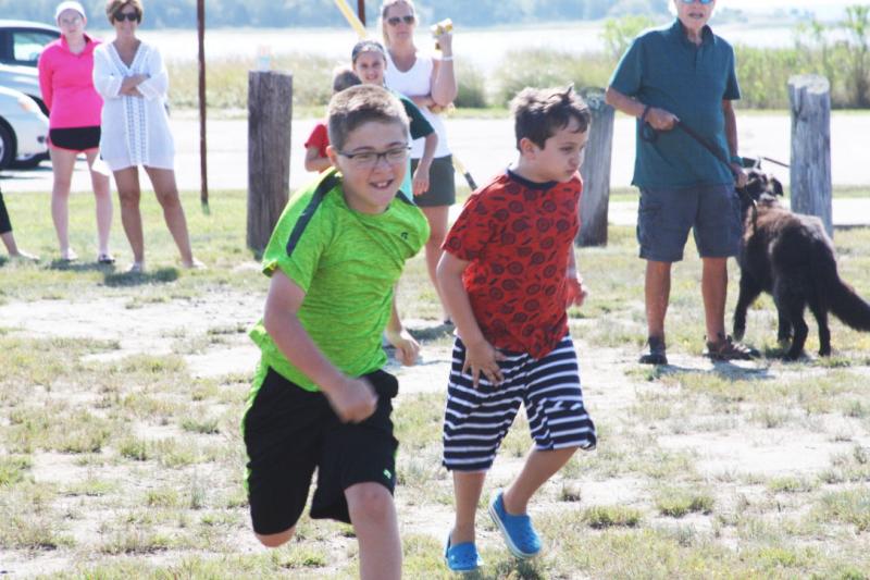 Boys compete in foot races for their age group. Foot race competitions were held in groups from age 2 to grandparents. BY LYDIA GOERNER