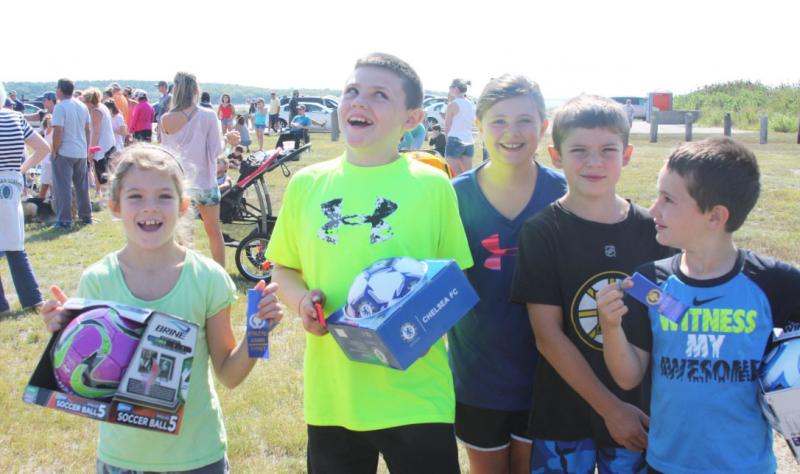 Foot race winners celebrate with their prizes, donated by the Swifts Beach Improvement Association. BY LYDIA GOERNER
