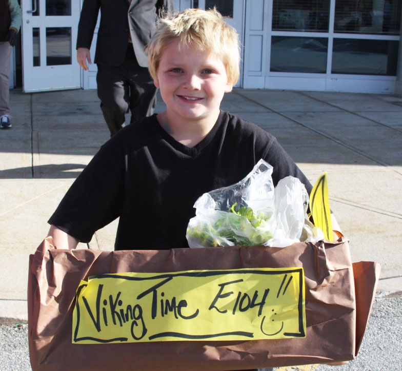 Wareham Middle School student Jason White carries a box of food donated by students to feed families on Thanksgiving. BY LYDIA GOERNER
