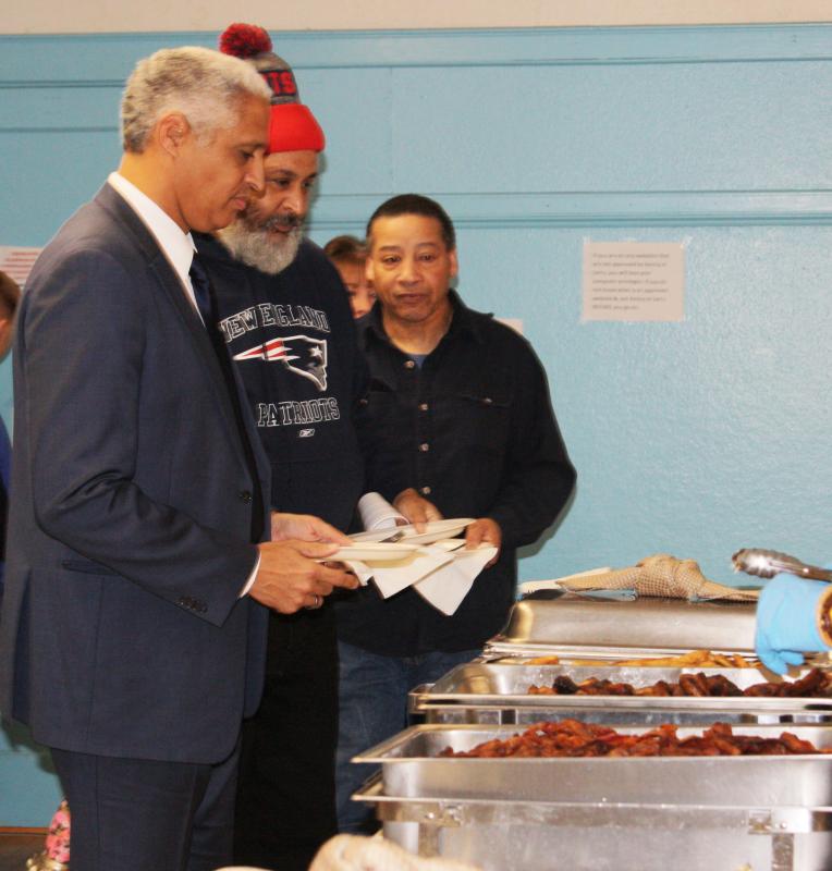 Speaker Edward Gomes piles his plate with breakfast, provided by "Big Daddy's Chef on Fire." BY LYDIA GOERNER