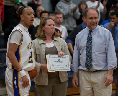 Jordan Resendes is presented with a certificate of achievement from WHS Athletic Director Tina Clark and head coach Kevin Brogioli BY ANDREW W. GRIFFITH
