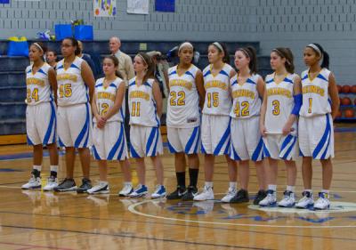 The Wareham Lady Vikings line up for the National Anthem before the last regular season home game Tuesday night. BY ANDREW W. GRIFFITH
