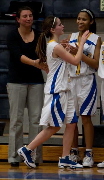 Senior Christine O'Toole is congratulated by teammate Lexi Silvia after scoring 27 points in Tuesdays win over Fairhaven. BY ANDREW W. GRIFFITH