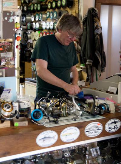 Owner Michael Thomas rewinds a customer's reel in preparation for the season. He estimates that in 27 years in business, he's strung approximately 5.25-million yards of line - using 70 spools with 3,000 yards of line per year. BY ANDREW W. GRIFFITH