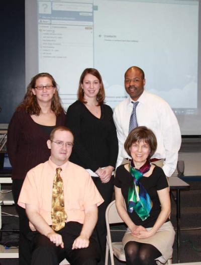 Wareham teachers practiced using Skype in preparation for forums with local students and students in Cape Verde in mid-April. Left to right: Background: middle school math teacher Jessica Frazier, high school history teacher Jessica Yttredahl, high school history teacher Henry St. Julien; Foreground: middle school history teacher Brian Fitzgerald, and Hammond and Decas Elementary art teacher Ellen Osborn BY JAIME REBHAN