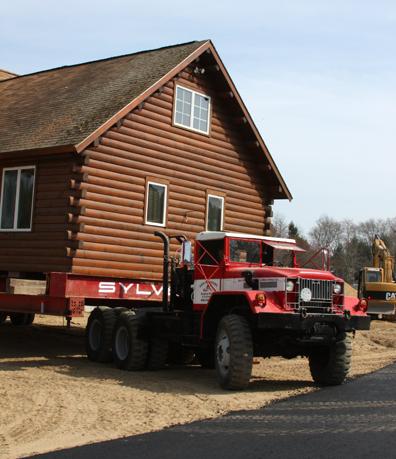 Gary Sylvester's Building Movers and Excavators use a 1967 Army Truck to haul the home. The interior of the truck is still olive green. BY JAIME REBHAN