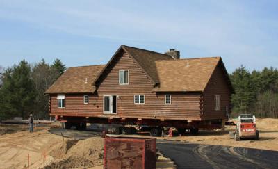 The road had just been paved that morning so was still a little soft...but not as soft as the sand beneath the left rear-wheel. Shovels were required to dig out the wheel base as it dug itself into a hole. The "floating" hydraulic system, however, kept the house level throughout. BY JAIME REBHAN