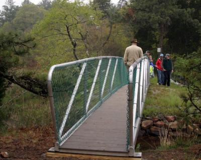 A new footbridge spans the brook at the same location where cars once sped down Head of the Bay Road. BY CYRUS MOULTON