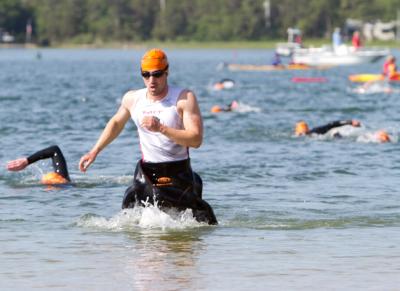 Athletes emerge from the water and make their way to the transition area, where they grabbed their bikes and started on the cycling portion of the triathlon. BY ANDREW W. GRIFFITH