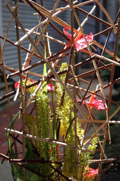 Detail of the display by Murphy, revealing a lattice of twigs, some of them peeled, tied together. BY CYRUS MOULTON