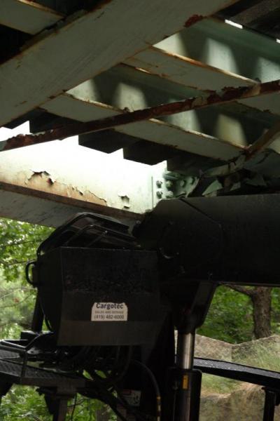A closeup of the truck's boom wedged in beneath the bridge, and some of the damaged bridge. BY CYRUS MOULTON