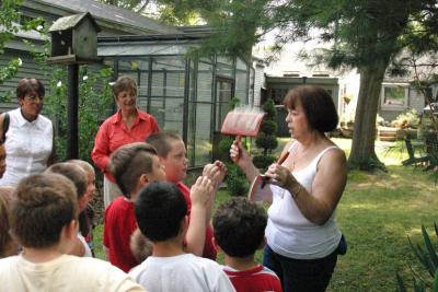 Carolyn McMorrow demonstrates how to card wool, while Christine Decas, of the Wareham Garden Club, left, and Wareham Boys and Girls Club Unit Director Barbara Sullivan, look on. BY CYRUS MOULTON