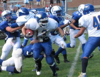 Senior co-captain Matt Pimental was not able to break the grasp of a Fairhaven defender on this play, but he combined with Darien Fernandez and the rest of the Wareham offense to overpower the Fairhaven defense. BY PATRICK LESTER