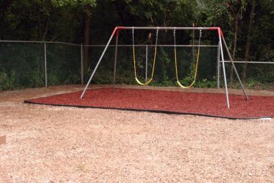 The swing set is old, but the swings and the surrounding "landing pad," are new. The mulch is actually made of rubber! BY CYRUS MOULTON
