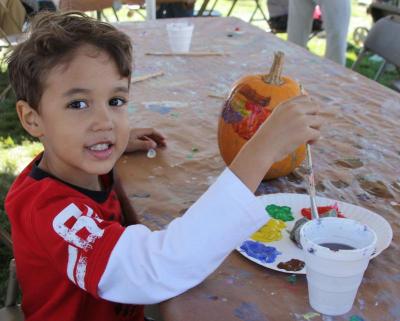 There was plenty to do at the Cranberry Harvest Celebration, even pumpkin decorating! Five-year-old Myles Lopes, of Wareham, paused for a picture before choosing the next color he would add to his very festive pumpkin. BY JAIME REBHAN