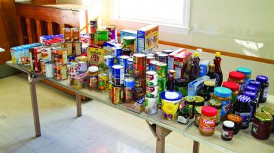 An array of canned goods donated by local churches helped supplement the Thanksgiving dinners, helping those craving some post-dinner snacks. BY ANDREW W. GRIFFITH