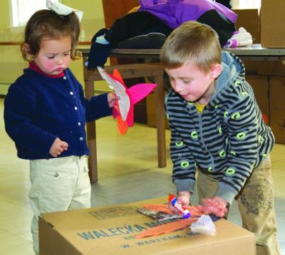 Emma and Robert Sylvia help specially decorate the boxes that will be delivered to those in need. BY ANDREW