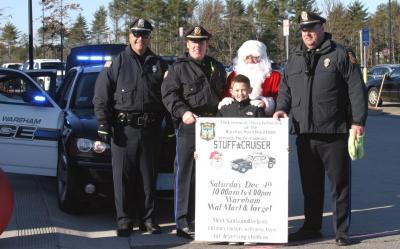 Patrolman Dean Decas, Lt. Kevin Walsh and Lt. John Walcek and Lt. Walsh's son Connor join Santa Claus outside Target. BY CYRUS MOULTON