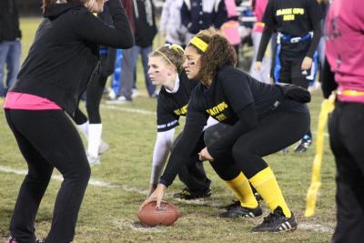 Ready, set, hike! The center for The Black Ops gets ready to snap the ball to the quarterback, as they face off against The Harajuku Barbies at Thursday night's Powderpuff football game. BY BARBARA THOMAS