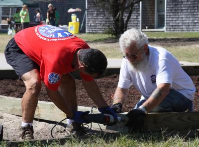 Lowe's volunteers enclosed an existing playground structure at Decas Elementary with new timbers. BY JAIME REBHAN